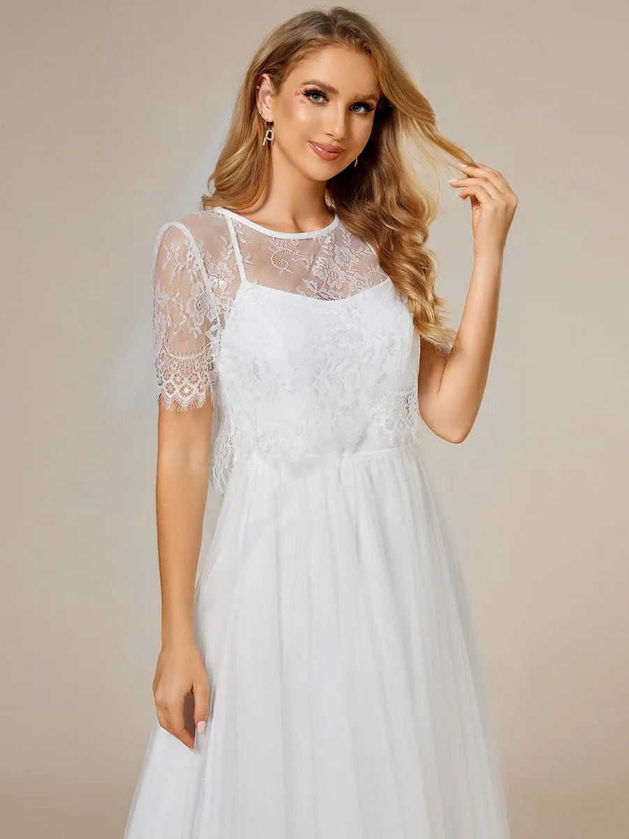 Whisper ivory soft knit and tulle cross back wedding dress and top
